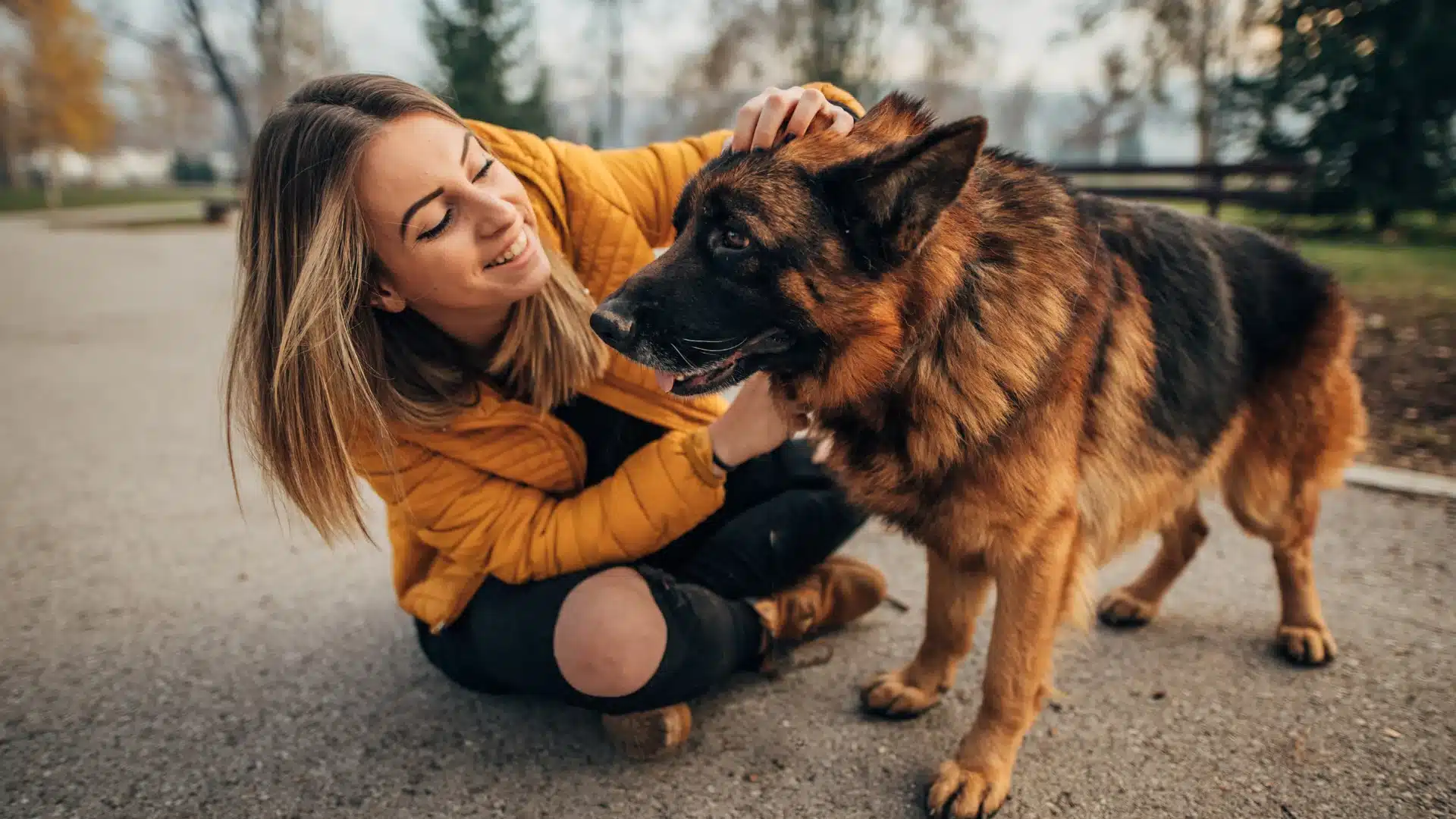 Woman hugging her dog outdoors showing love, trust, and healthy pet lifestyle